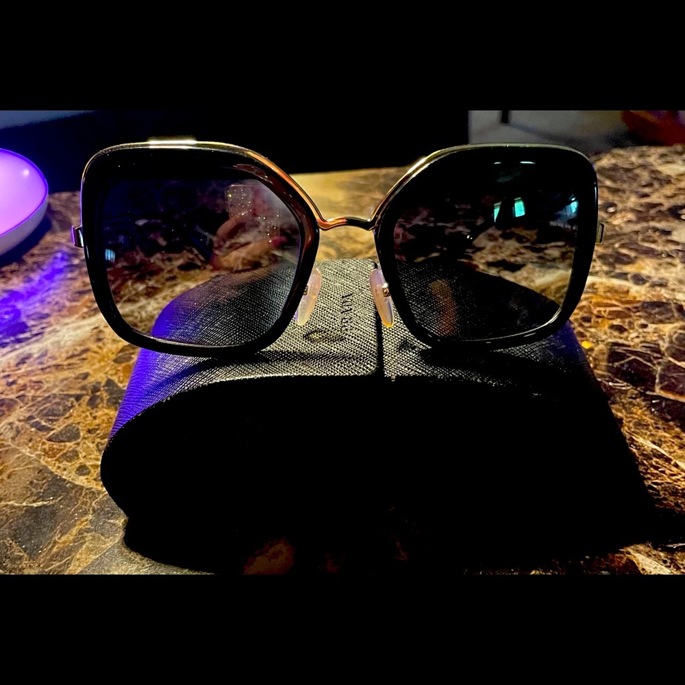 Oversized black and gold Prada sunglasses